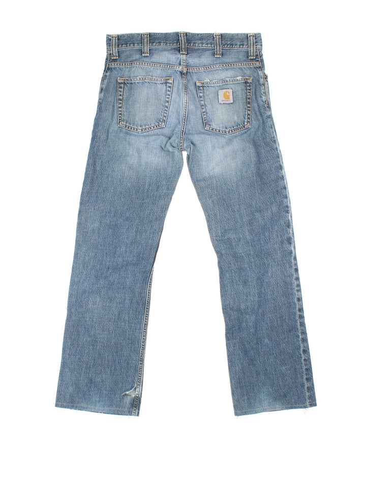 Carhartt Rockin Pant Jeans in a blue colourway with multiple pockets and the logo embroidered on the back.
