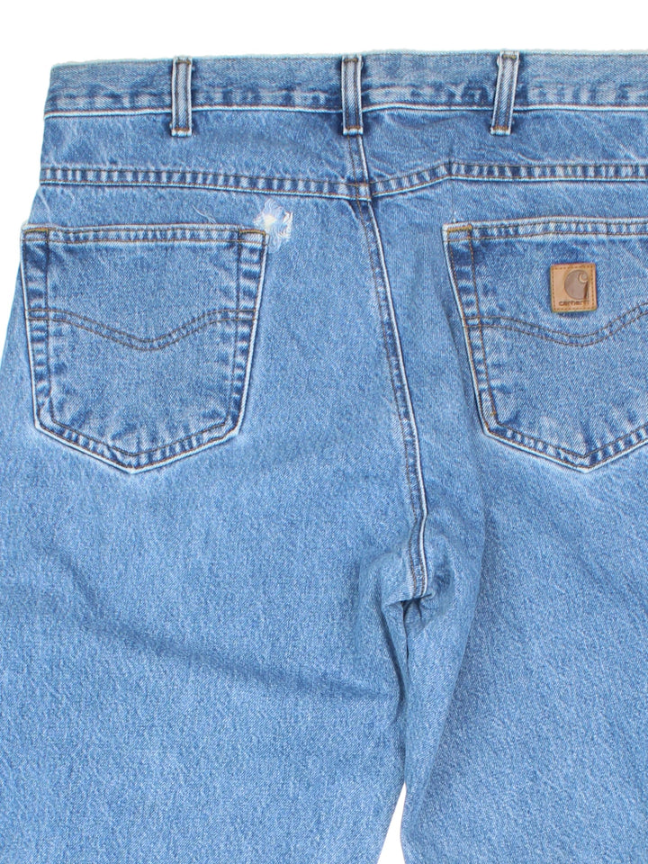 Carhartt Jeans in a blue colourway with multiple pockets and the logo embroidered on the back.
