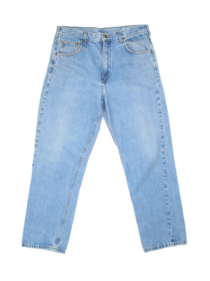 Carhartt Jeans in a blue colourway with multiple pockets and the logo embroidered on the back.