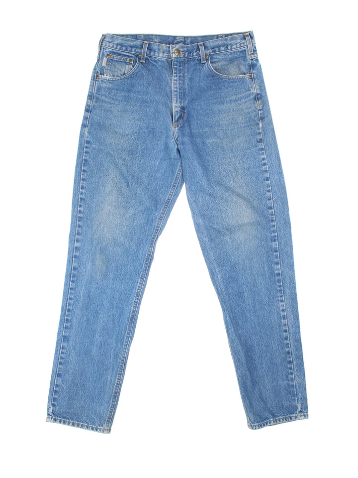Carhartt Jeans in a blue colourway with multiple pockets and the logo embroidered on the back.