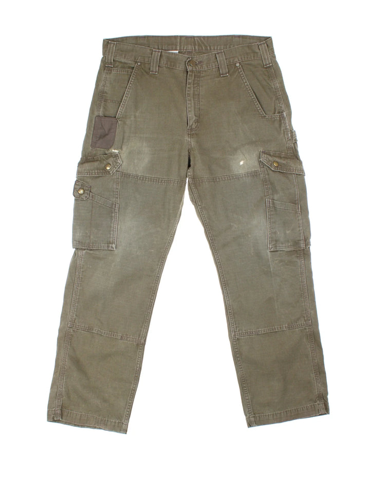 Carhartt Cargo Trousers in a green colourway with multiple pockets and the logo embroidered on the back.