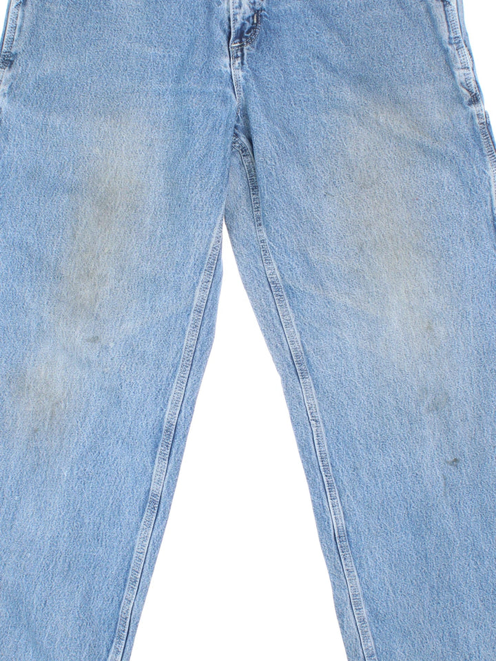 Carhartt Jeans in a blue colourway with multiple pockets and the logo embroidered on the back.