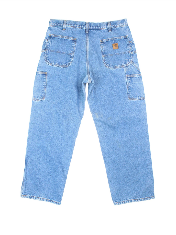 Carhartt Thermal Lined Carpenter Jeans in a blue colourway with multiple pockets and the logo embroidered on the back.