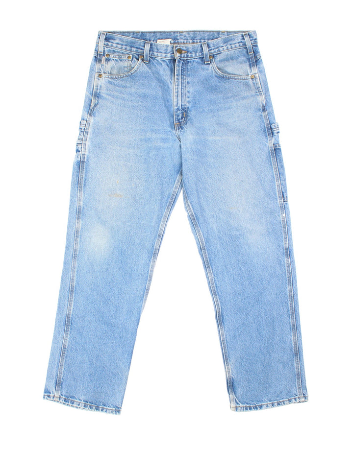Carhartt Carpenter Jeans in a blue colourway with multiple pockets and the logo embroidered on the back.
