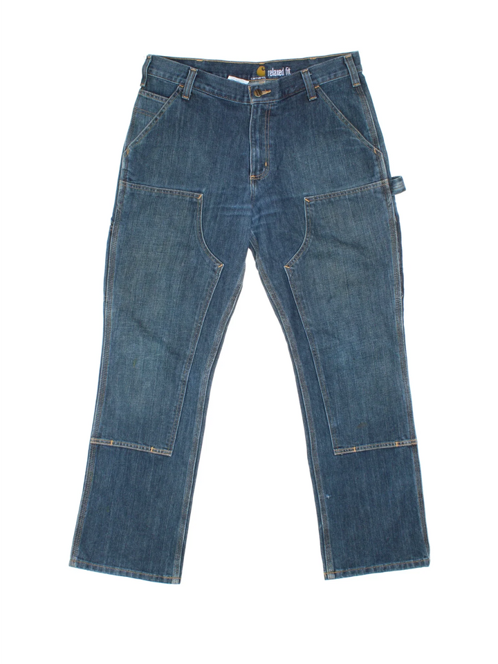 Carhartt Double Knee Jeans in a blue colourway with multiple pockets and the logo embroidered on the back.