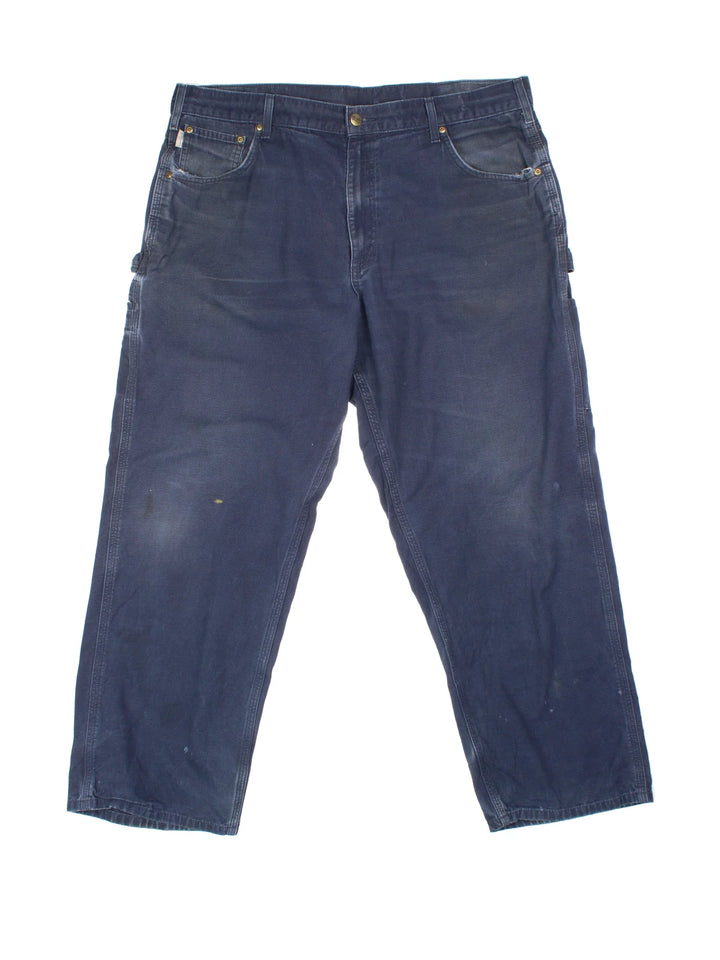 Carhartt Carpenter Trousers in a blue colourway with multiple pockets and the logo embroidered on the back.