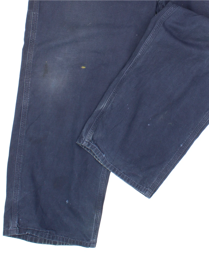 Carhartt Carpenter Trousers in a blue colourway with multiple pockets and the logo embroidered on the back.