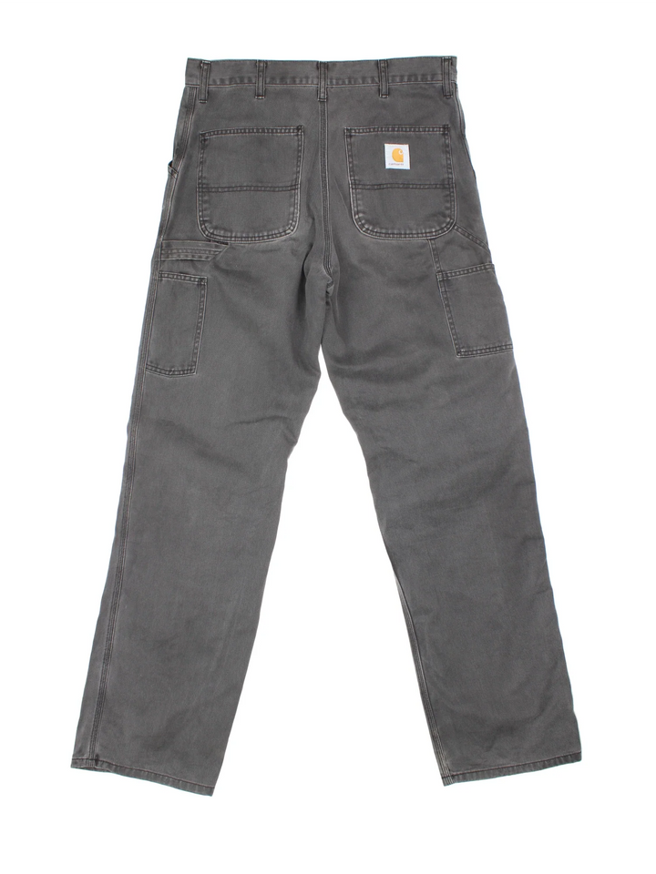 Carhartt Trousers in a grey colourway with multiple pockets and the logo embroidered on the back.