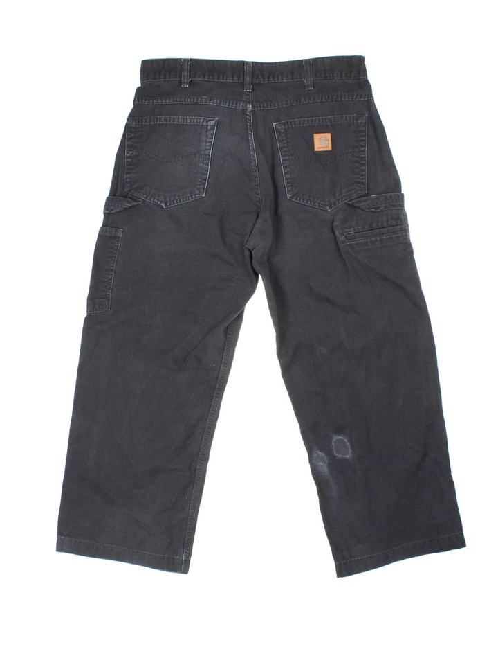 Carhartt Carpenter Trousers in a black colourway with multiple pockets and the logo embroidered on the back.