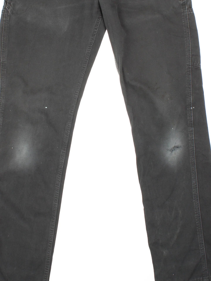 Carhartt Carpenter Trousers in a black colourway with multiple pockets and the logo embroidered on the back.