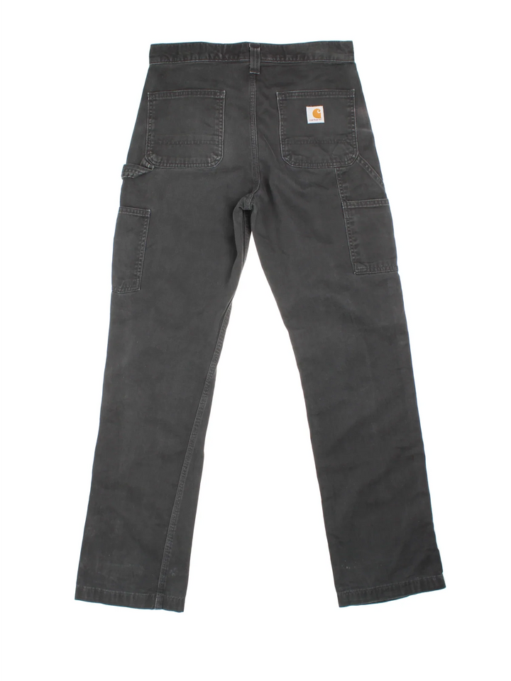 Carhartt Carpenter Trousers in a black colourway with multiple pockets and the logo embroidered on the back.