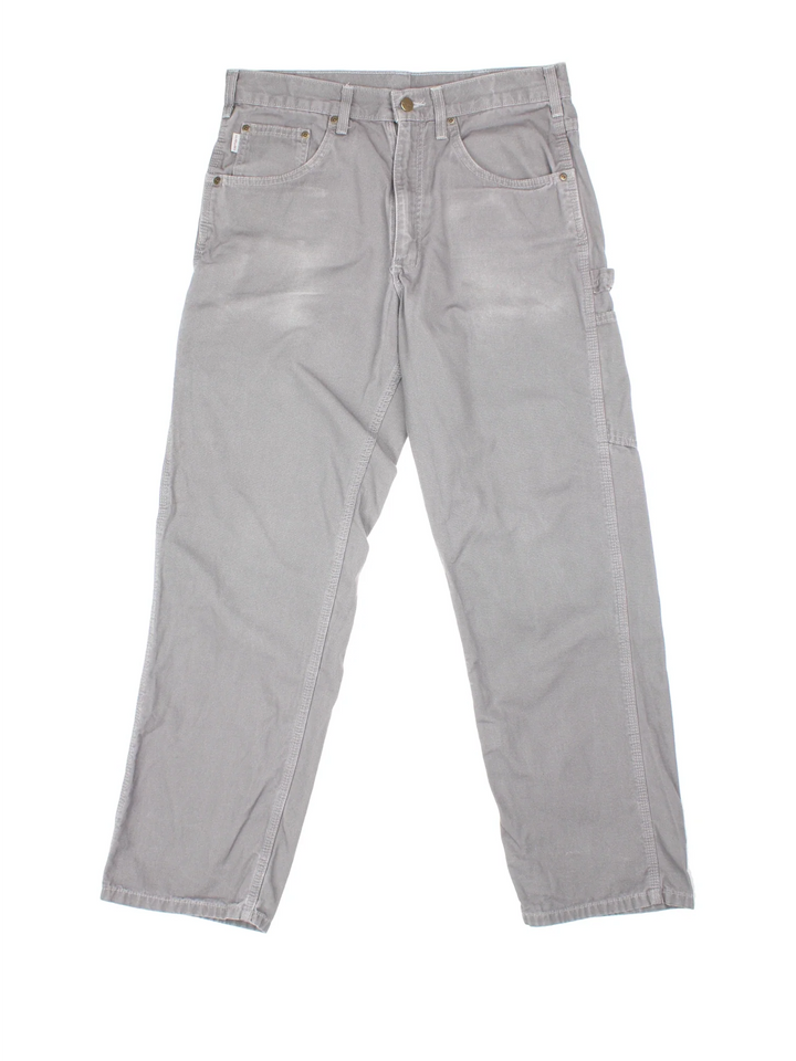 Carhartt Carpenter Trousers in a grey colourway with multiple pockets and the logo embroidered on the back.