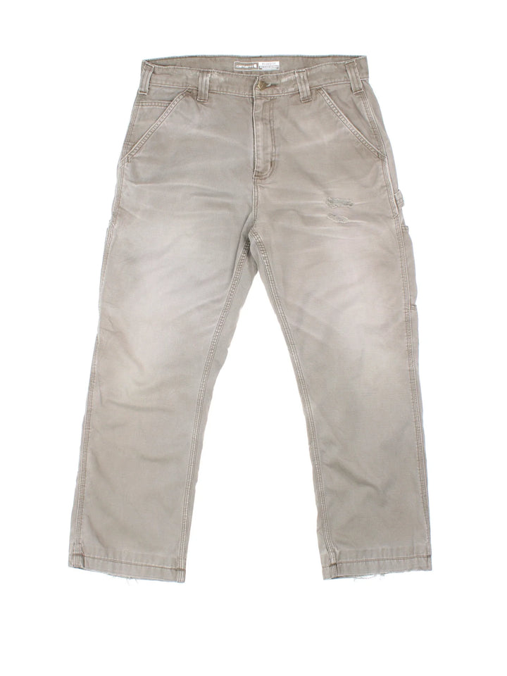 Carhartt Carpenter Trousers in a grey colourway with multiple pockets and the logo embroidered on the back.