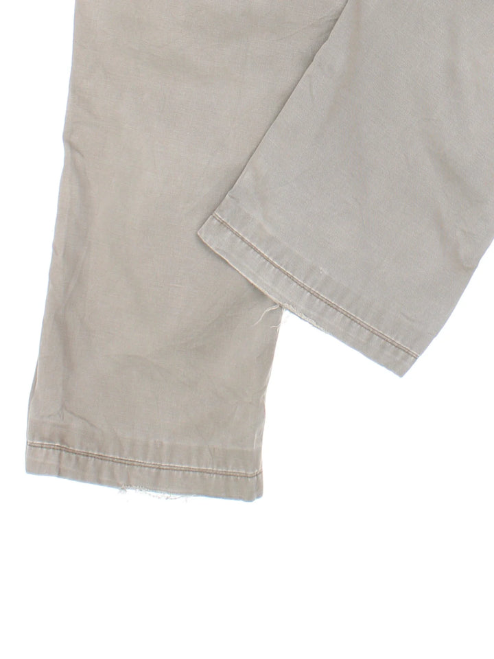 Carhartt Carpenter Trousers in a grey colourway with multiple pockets and the logo embroidered on the back.