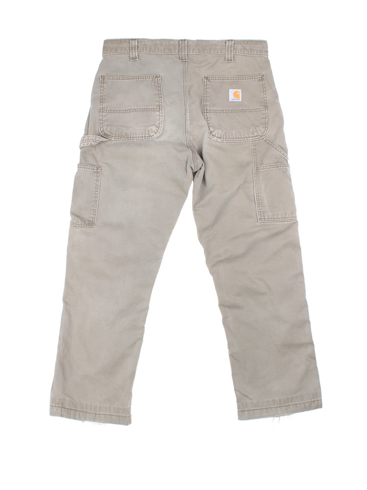 Carhartt Carpenter Trousers in a grey colourway with multiple pockets and the logo embroidered on the back.