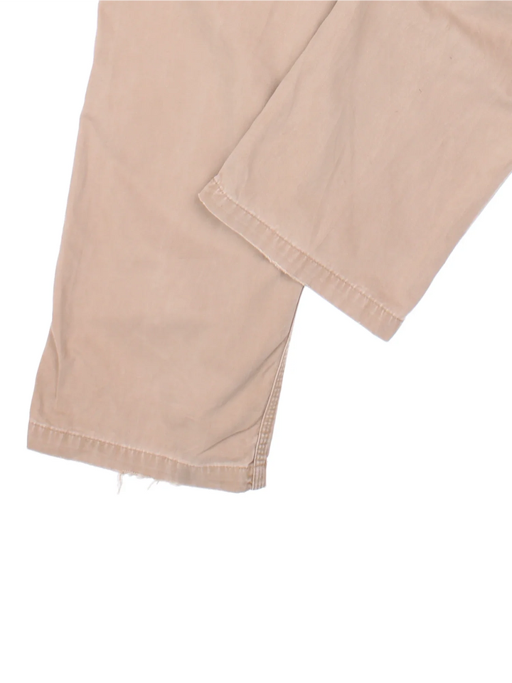 Carhartt Carpenter Trousers in a tan colourway with multiple pockets and the logo embroidered on the back.
