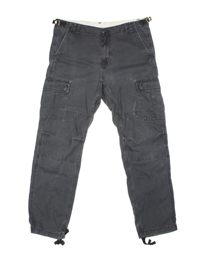 Carhartt Cargo Trousers in a black colourway with multiple pockets and the logo embroidered on the back.