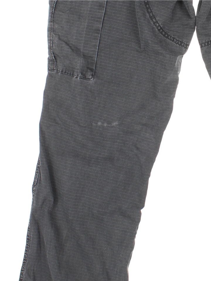 Carhartt Cargo Trousers in a black colourway with multiple pockets and the logo embroidered on the back.