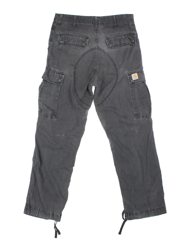 Carhartt Cargo Trousers in a black colourway with multiple pockets and the logo embroidered on the back.