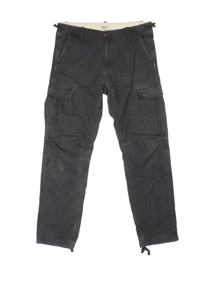 Carhartt Cargo Trousers in a black colourway with multiple pockets and the logo embroidered on the back.