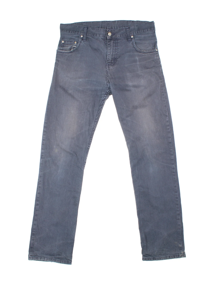 Carhartt Jeans in a blue colourway with multiple pockets and the logo embroidered on the back.