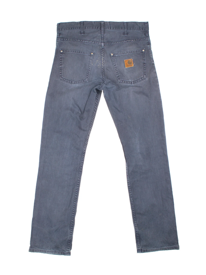 Carhartt Jeans in a blue colourway with multiple pockets and the logo embroidered on the back.