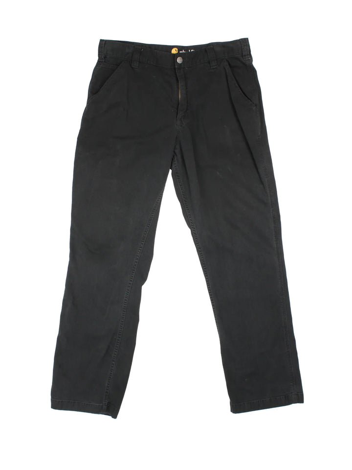 Carhartt Trousers in a black colourway with multiple pockets and the logo embroidered on the back.