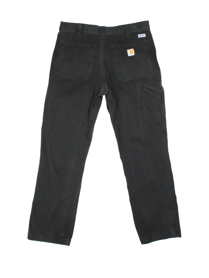 Carhartt Trousers in a black colourway with multiple pockets and the logo embroidered on the back.