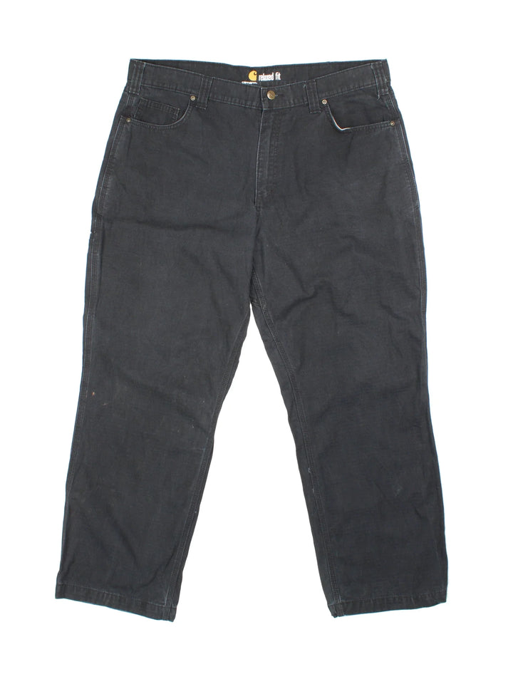 Carhartt Trousers in a black colourway with multiple pockets and the logo embroidered on the back.