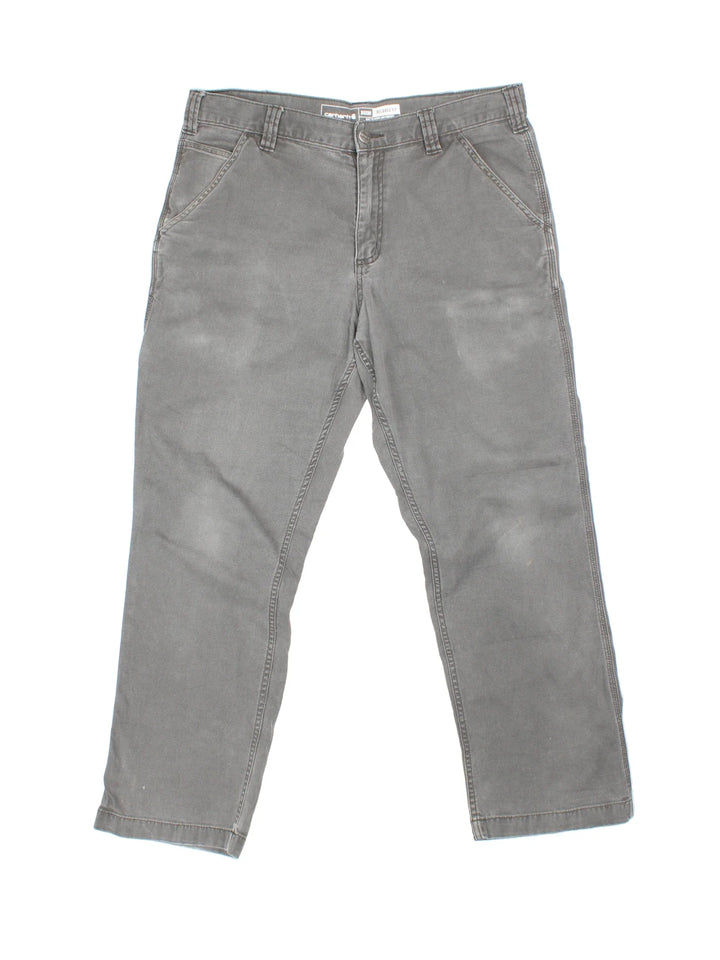 Carhartt Trousers in a grey colourway with multiple pockets and the logo embroidered on the back.