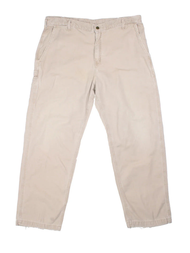 Carhartt Trousers in a tan colourway with multiple pockets and the logo embroidered on the back.