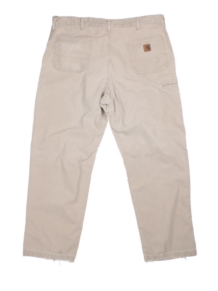 Carhartt Trousers in a tan colourway with multiple pockets and the logo embroidered on the back.