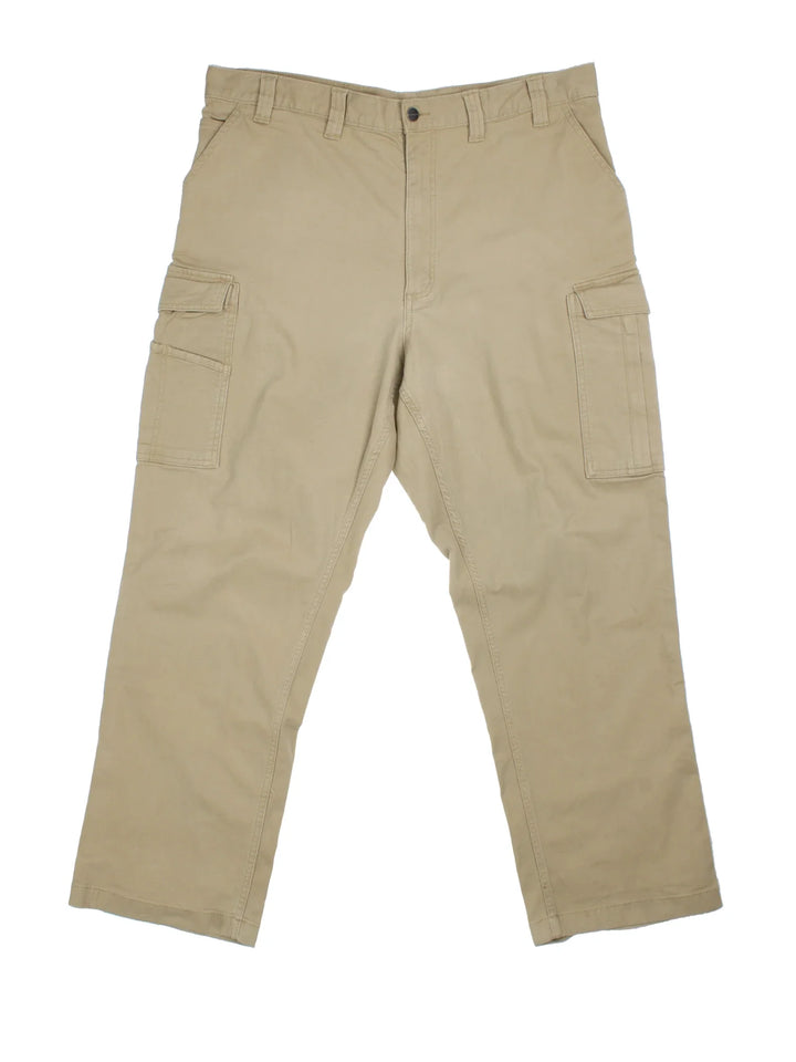 Carhartt Cargo Trousers in a tan colourway with multiple pockets and the logo embroidered on the back.