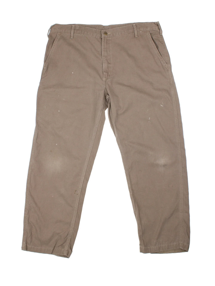 Carhartt Trousers in a brown colourway with multiple pockets and the logo embroidered on the back.