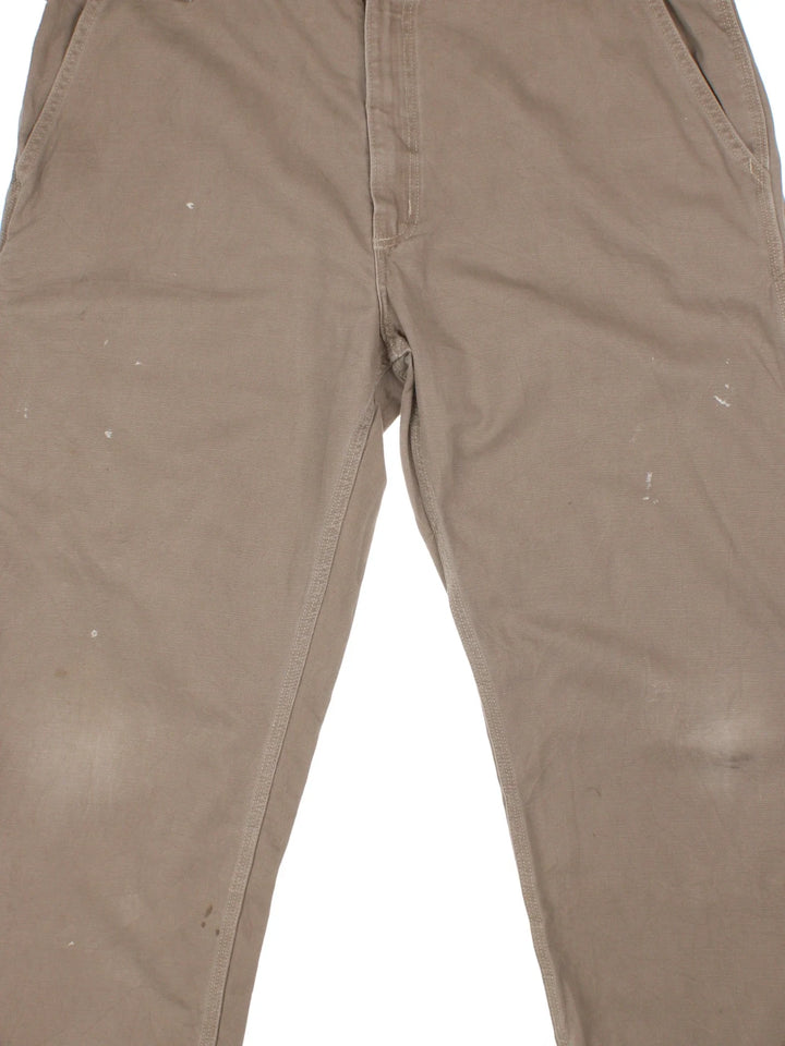 Carhartt Trousers in a brown colourway with multiple pockets and the logo embroidered on the back.