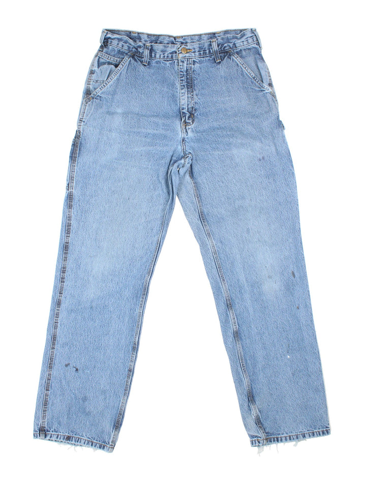 Carhartt Carpenter Jeans in a blue colourway with multiple pockets and the logo embroidered on the back.