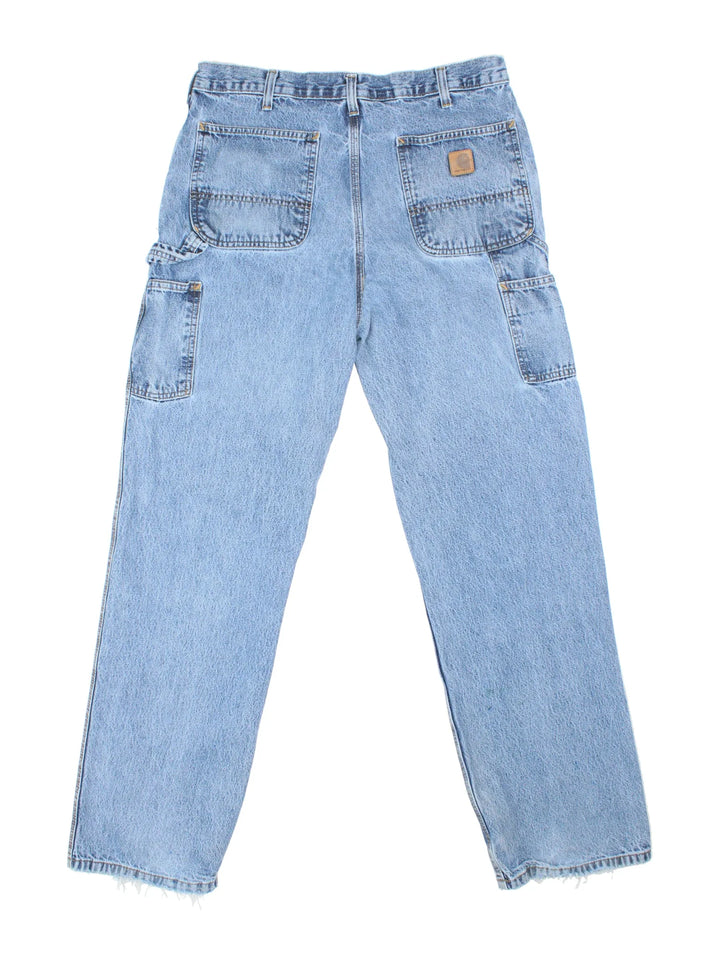 Carhartt Carpenter Jeans in a blue colourway with multiple pockets and the logo embroidered on the back.