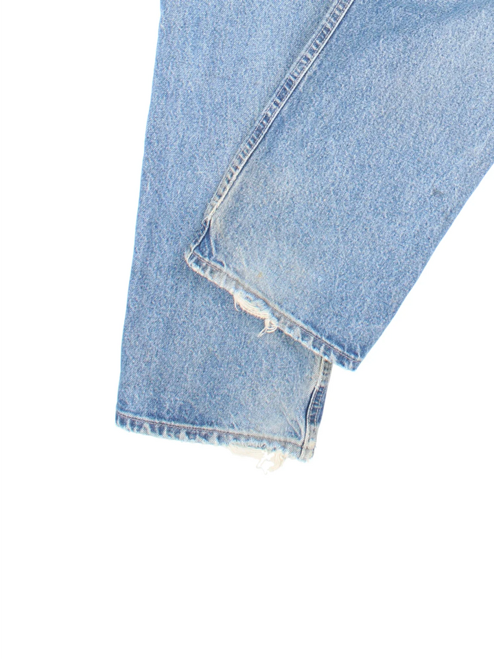 Carhartt Jeans in a blue colourway with multiple pockets and the logo embroidered on the back.