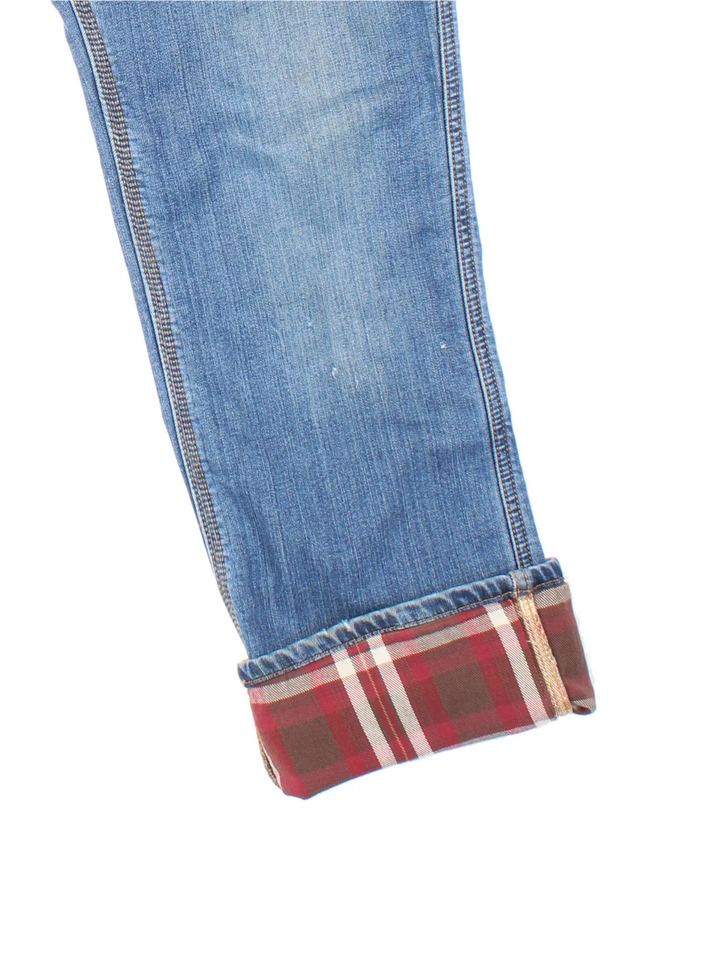 Carhartt Lined Jeans in a blue colourway, with multiple pockets, checked lining and the logo embroidered on the back.