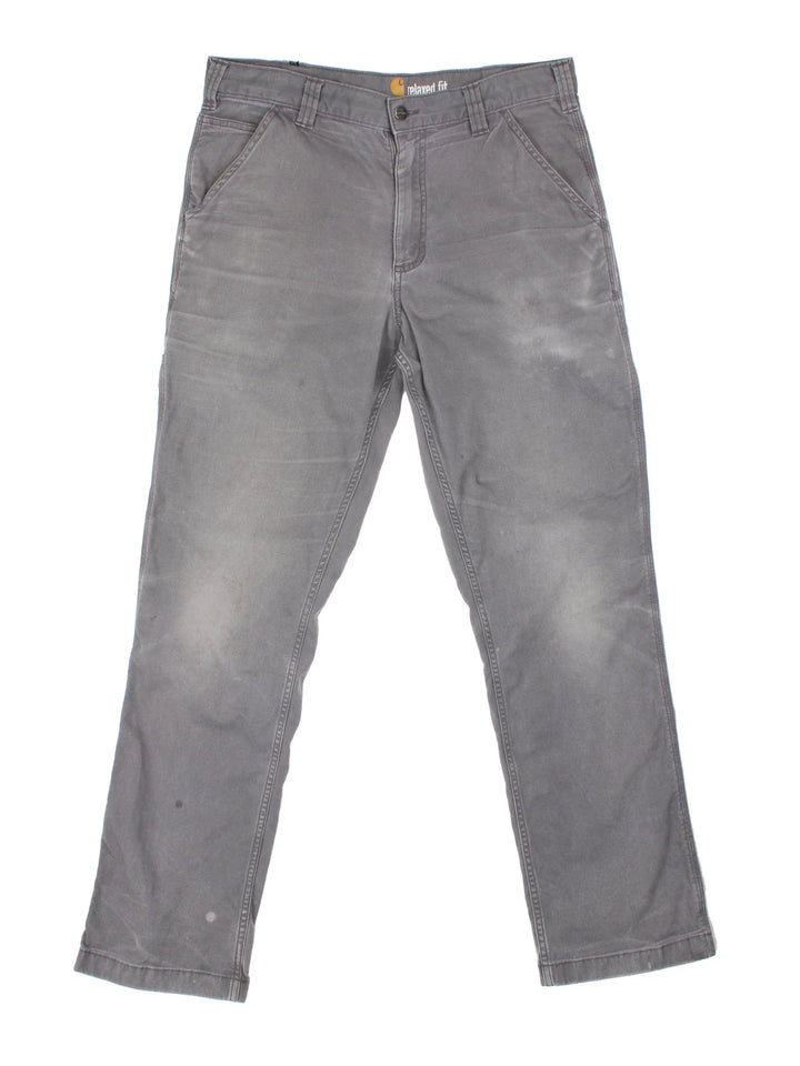 Carhartt Carpenter Trousers in a grey colourway with multiple pockets and the logo embroidered on the back.