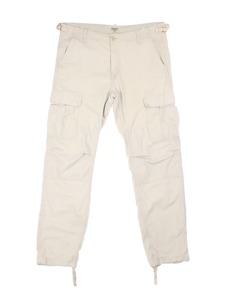 Carhartt Cargo Trouser in a tan colourway with multiple pockets and the logo embroidered on the back.