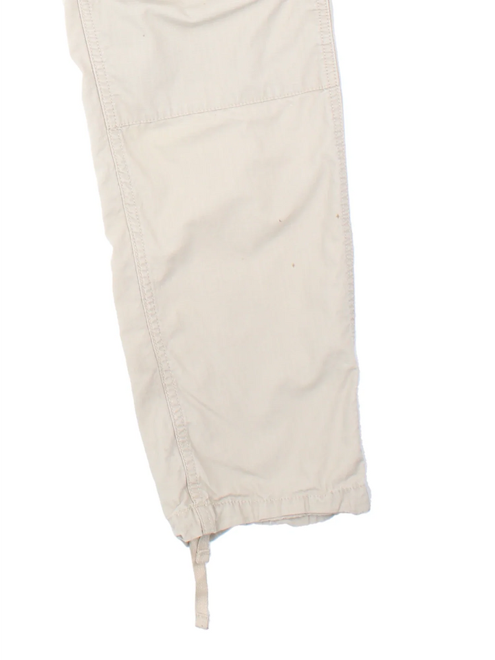 Carhartt Cargo Trouser in a tan colourway with multiple pockets and the logo embroidered on the back.