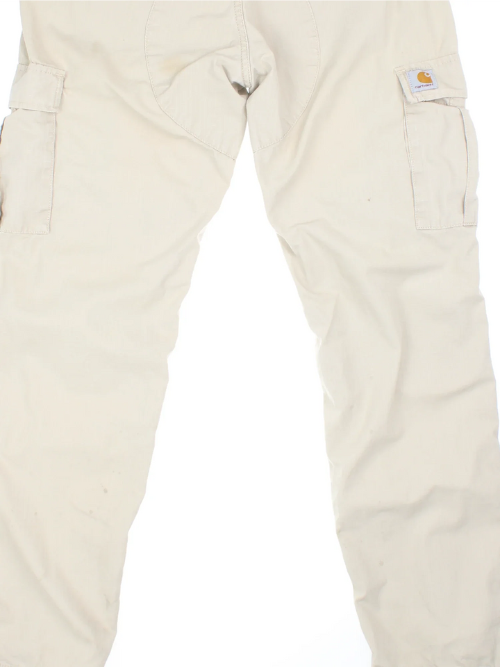 Carhartt Cargo Trouser in a tan colourway with multiple pockets and the logo embroidered on the back.