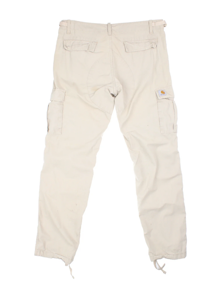 Carhartt Cargo Trouser in a tan colourway with multiple pockets and the logo embroidered on the back.
