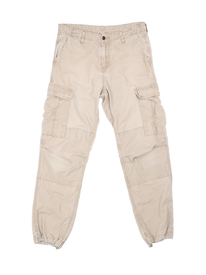 Carhartt Cargo Trouser in a tan colourway with multiple pockets and the logo embroidered on the back.