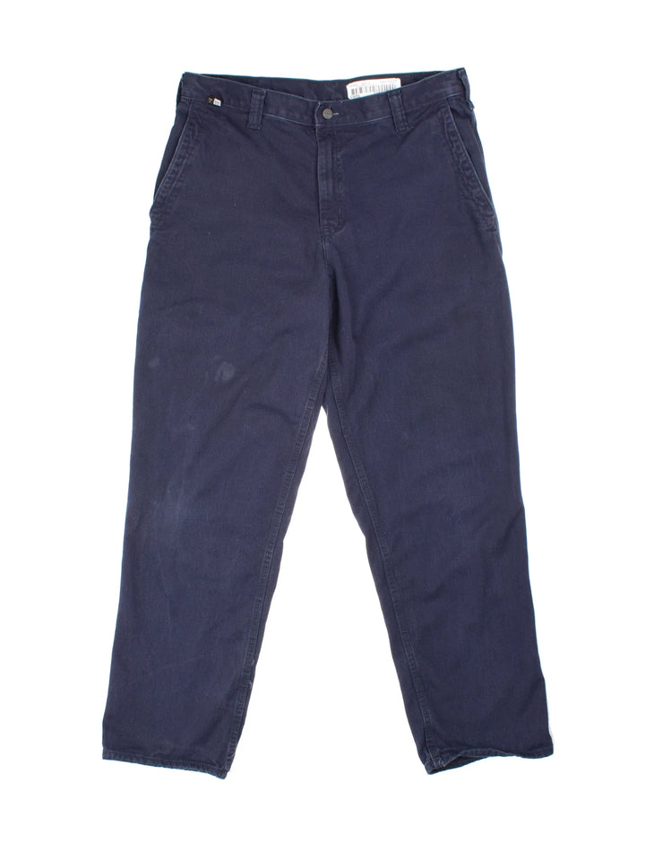 Carhartt Trousers in a blue colourway with multiple pockets and the logo embroidered on the back.