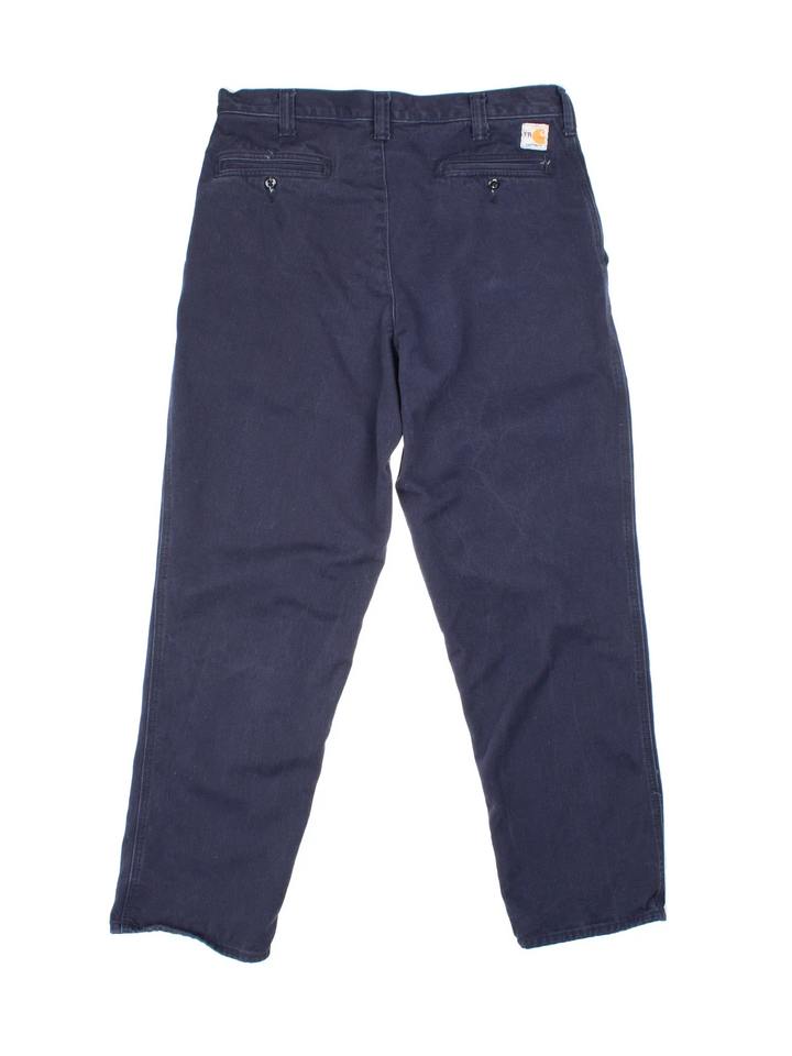 Carhartt Trousers in a blue colourway with multiple pockets and the logo embroidered on the back.