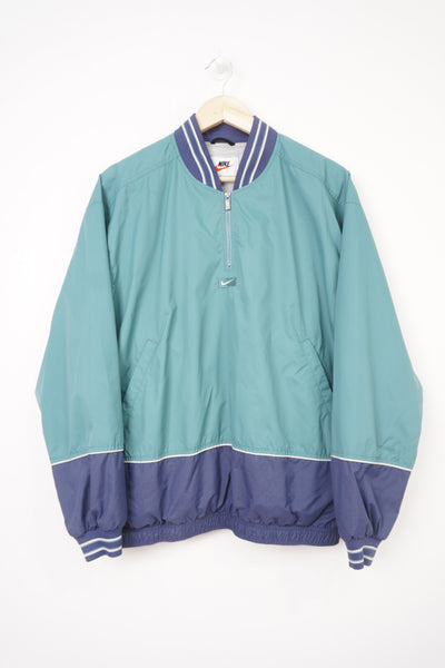 Vintage 90's light blue Nike 1/4 zip pullover jacket with embroidered logo on the chest and back
