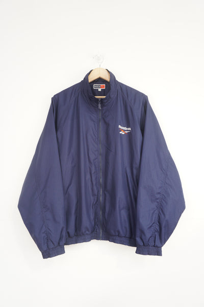 Vintage Reebok navy blue shell jacket with embroidered logo on the chest and back