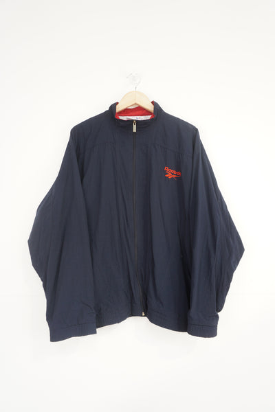 Vintage navy blue Reebok zip through track jacket with embroidered logo on the chest